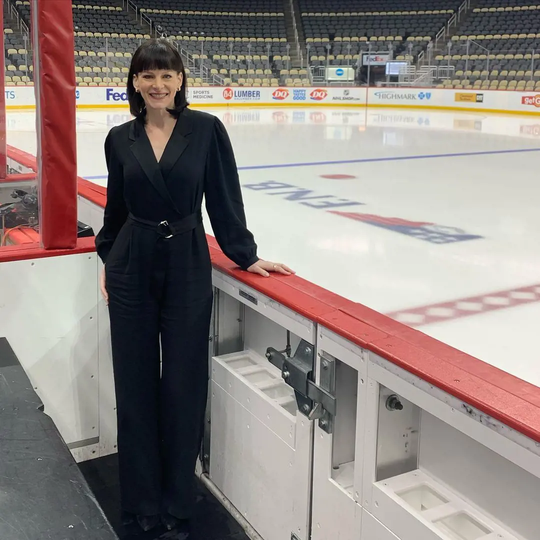 Leah posed wearing a dark jumpsuit at PPG Paints Arena