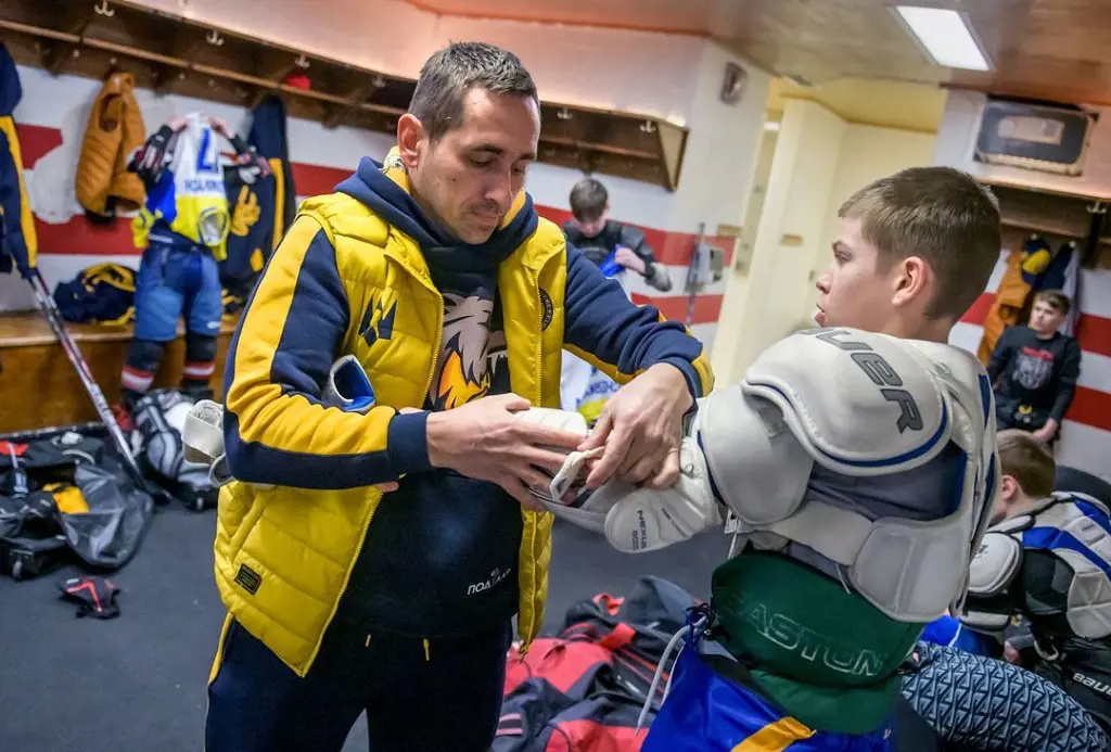 Youth hockey players from city of kharkiv wearing full set of equipment for an exhibition game against their American counterparts on March 23,2023